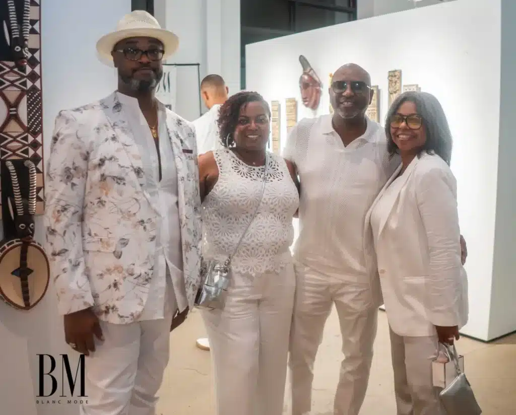 4 african-americans in all white at a party having a good time